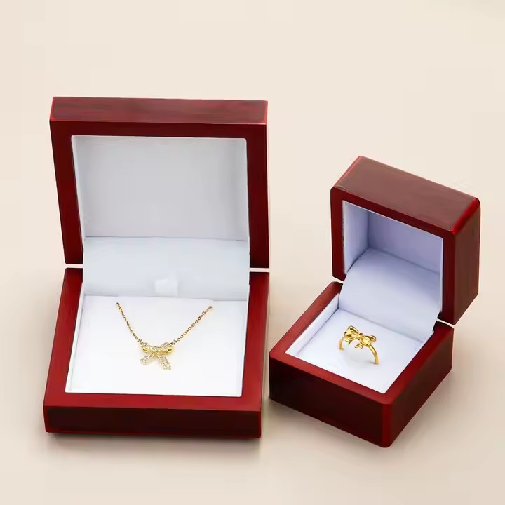 Luxury wooden jewelry box with ring slots and engraved logo
